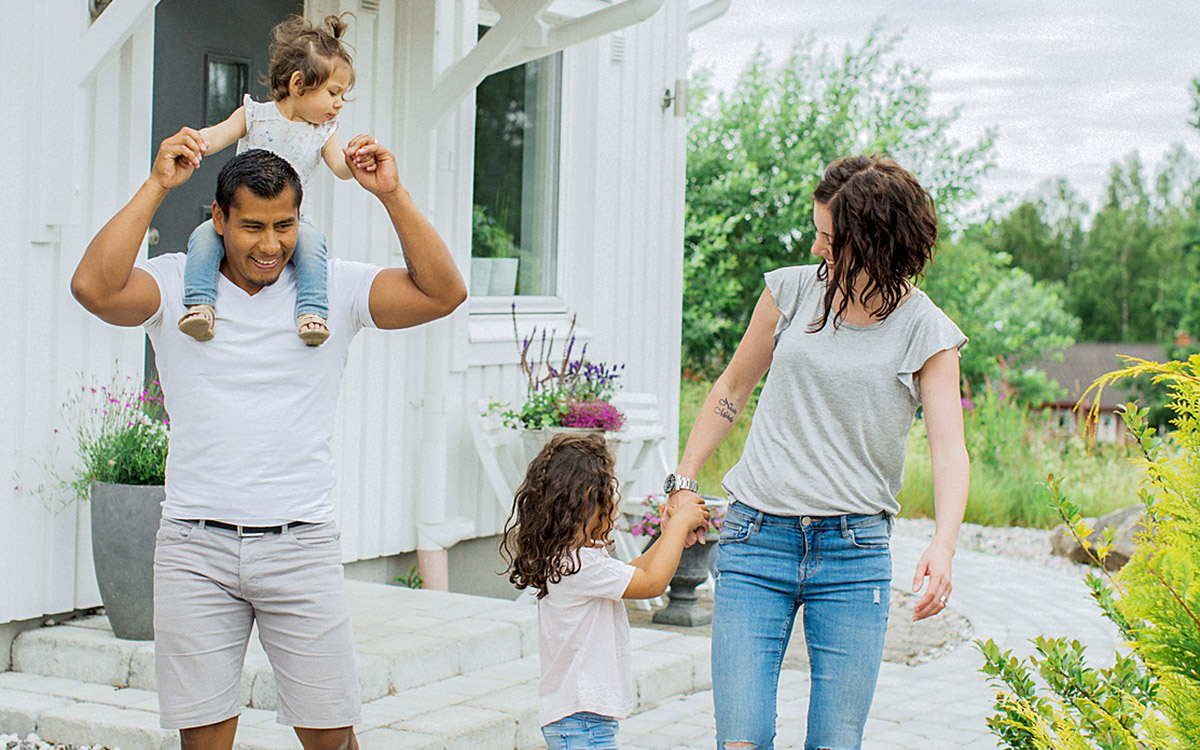 Glad familj utanför hus